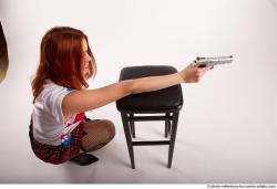 TINA KNEELING POSE WITH GUNS